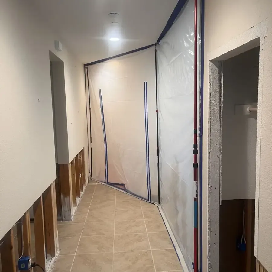 Tiled hallway with lower wall sections opened for drying